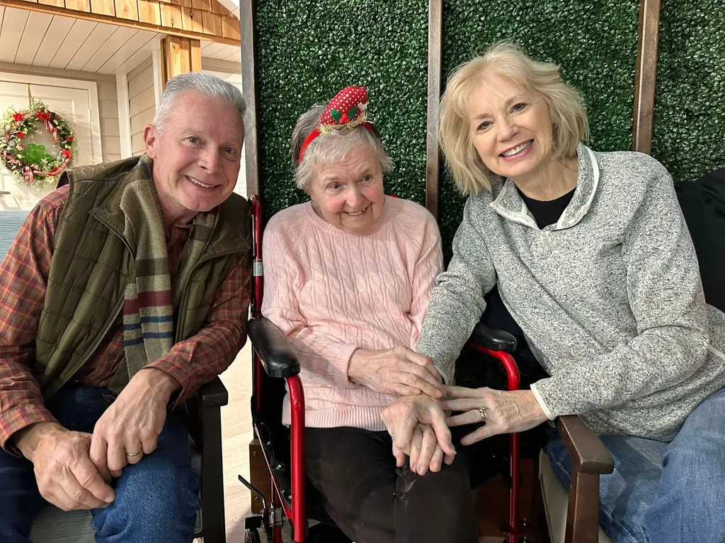 A memory care resident with two visiting family members.