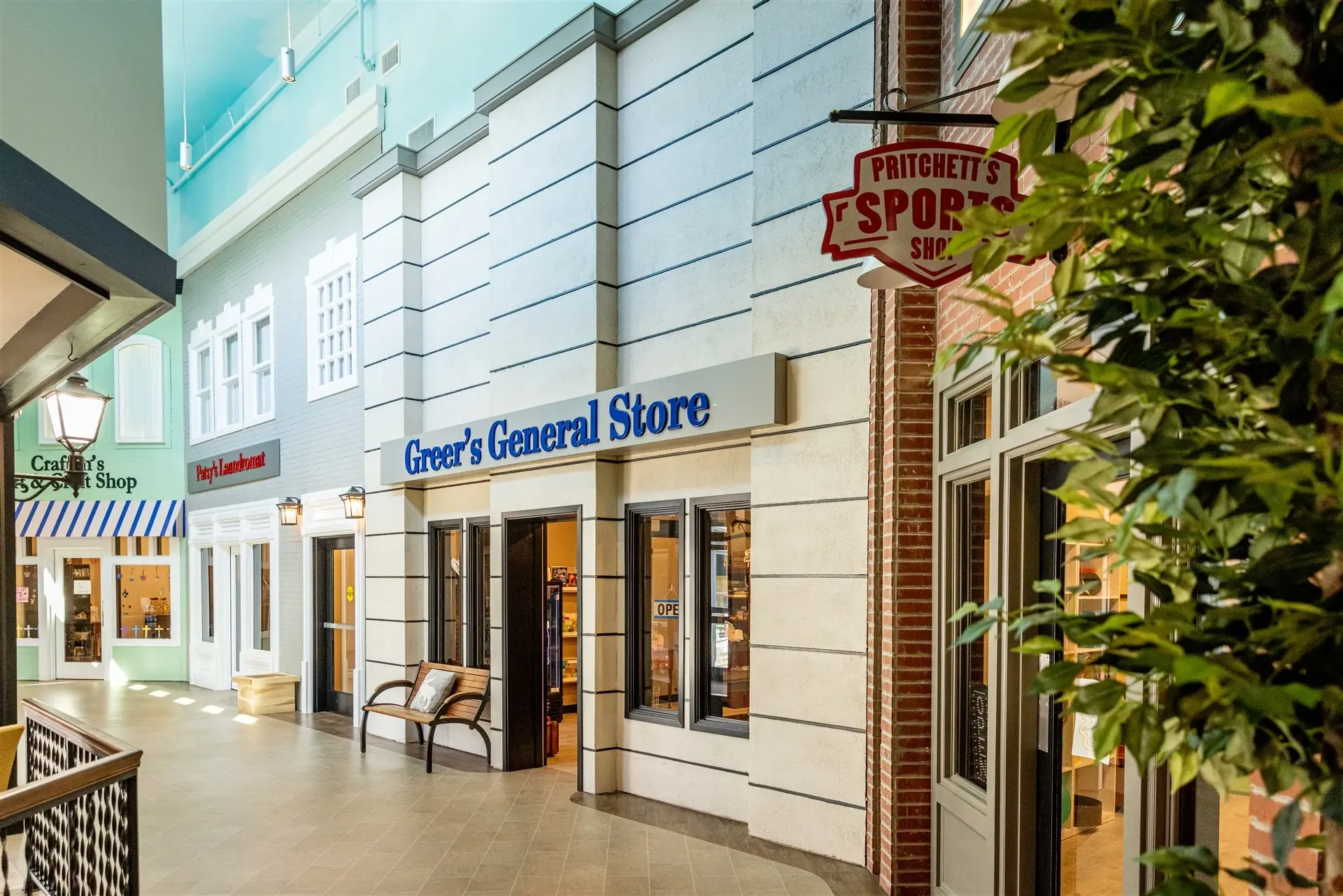Storefront facades and lamp posts along the indoor Main Street in Homeplace memory care