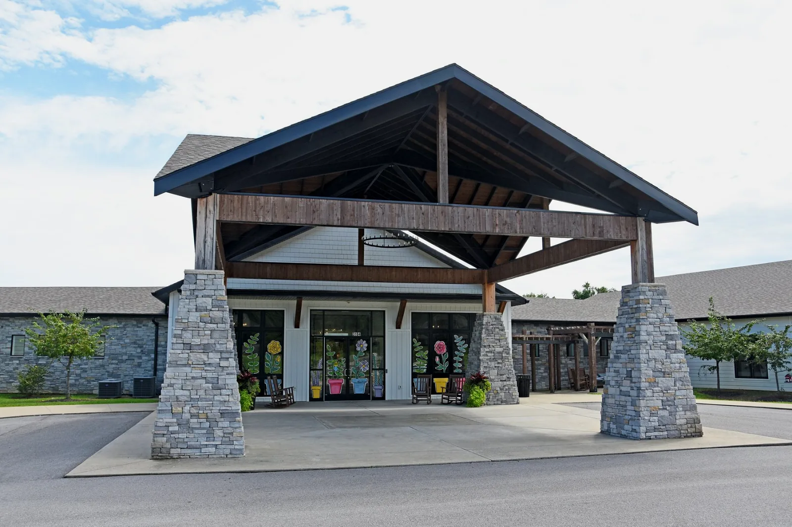The covered front entrance at Homeplace at Green River Road, with stone pillars.
