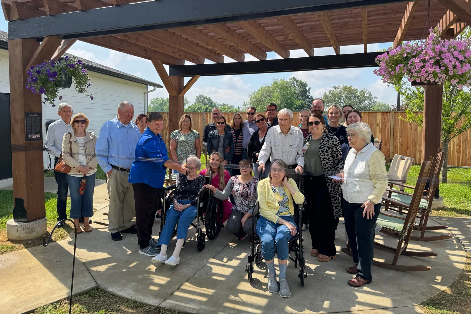 Residents, families and team members gathered for the ribbon cutting on the memory care pergola at Green River Road.